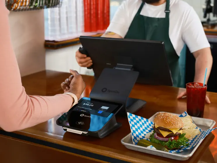 A quick-service restaurant counter: a customer paying for their order